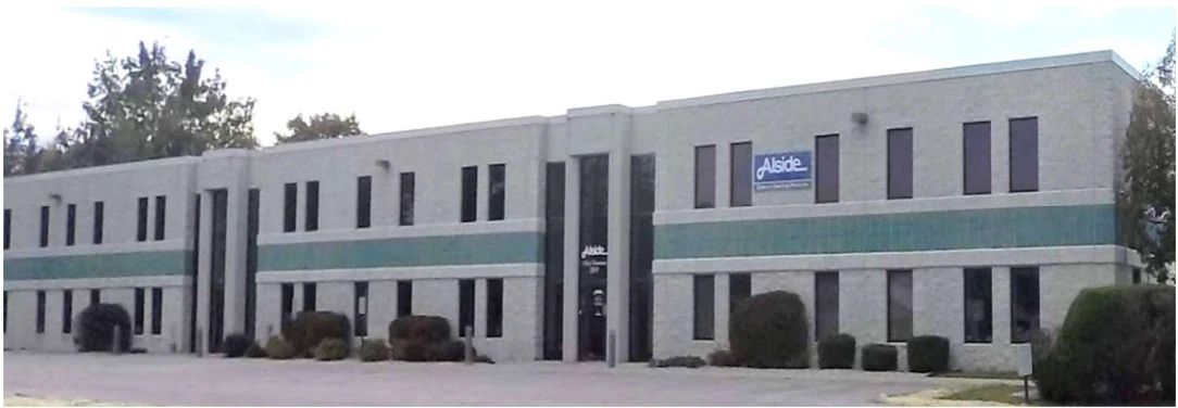 Exterior of the Luther Industrial building, a single-story light-industrial facility with Alside tenant signage