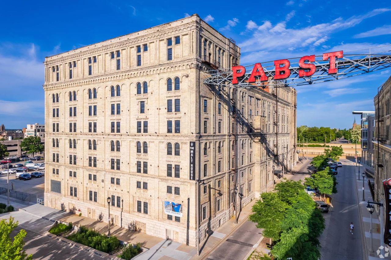 Aerial view of the Pabst Malt House building with the illuminated red PABST rooftop sign and 'The Malt House' signage